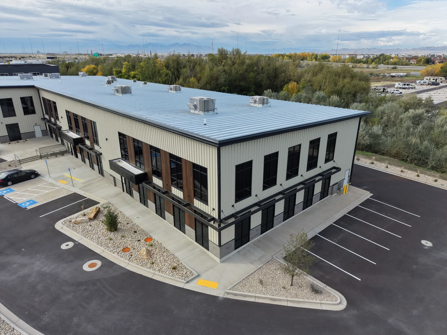 Aerial view of the recent Farmington commercial steel building with finished parking and storefront windows