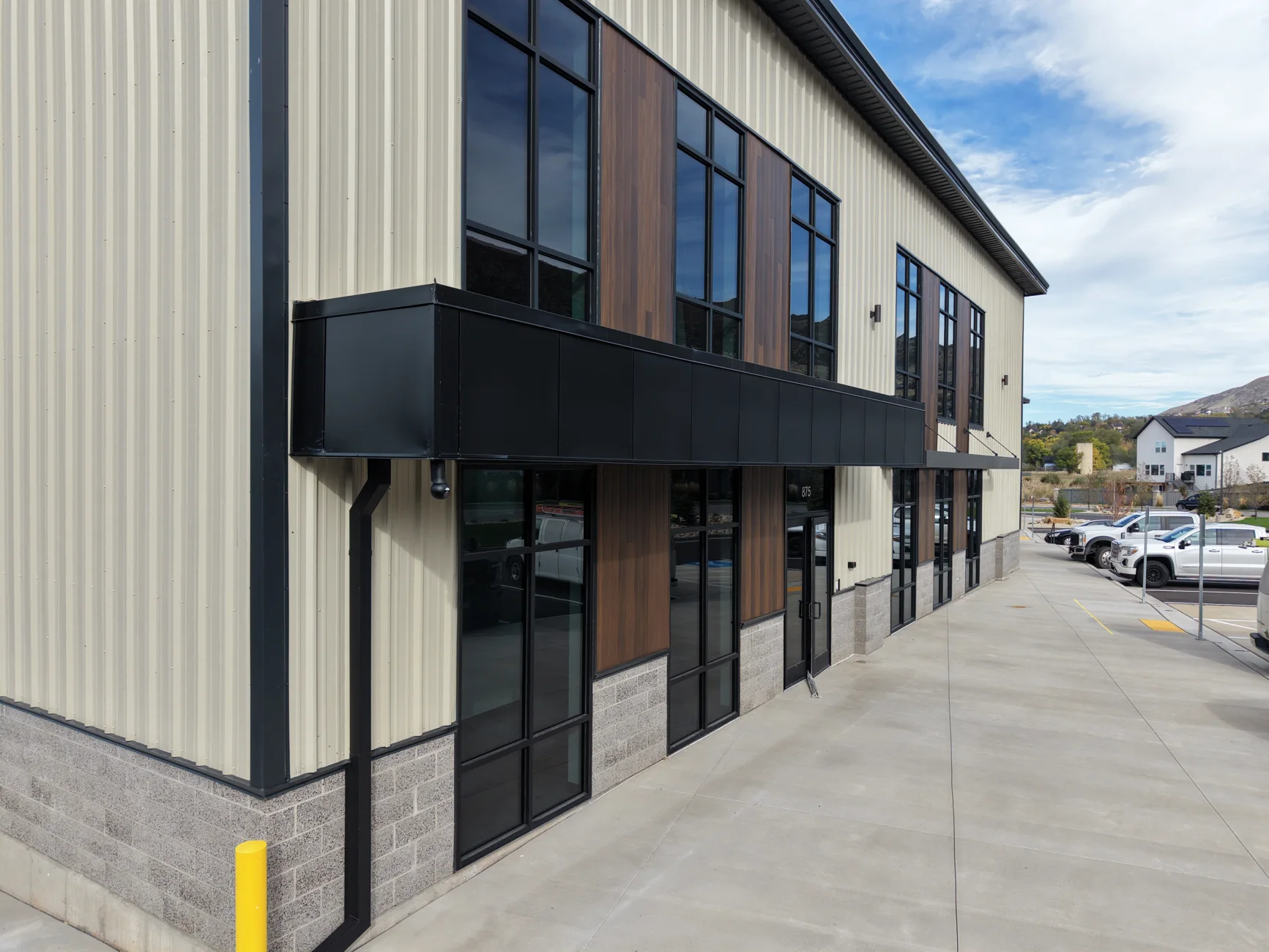 Farmington commercial building exterior with metal siding, tall windows, and covered walkway
