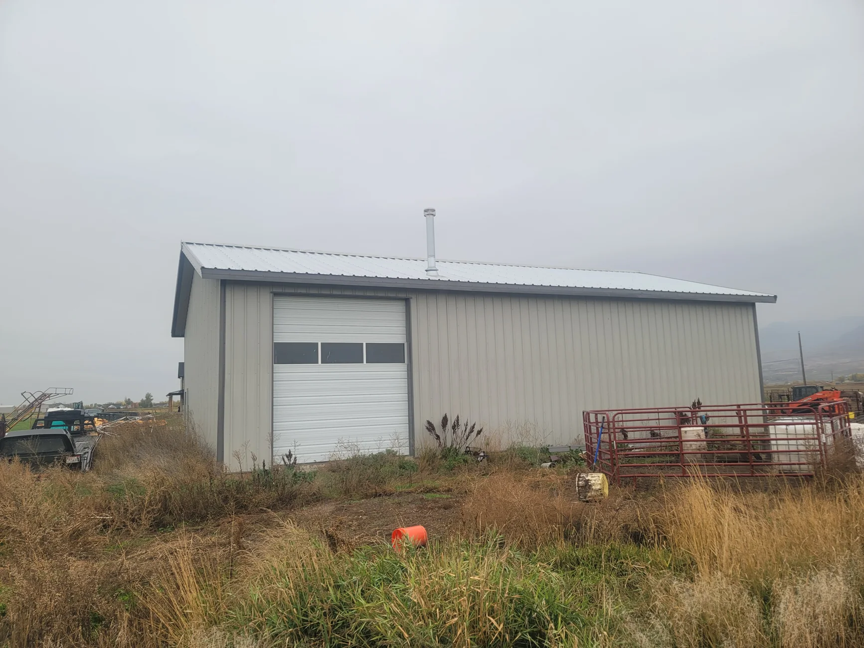 Metal garage exterior with an overhead vehicle door