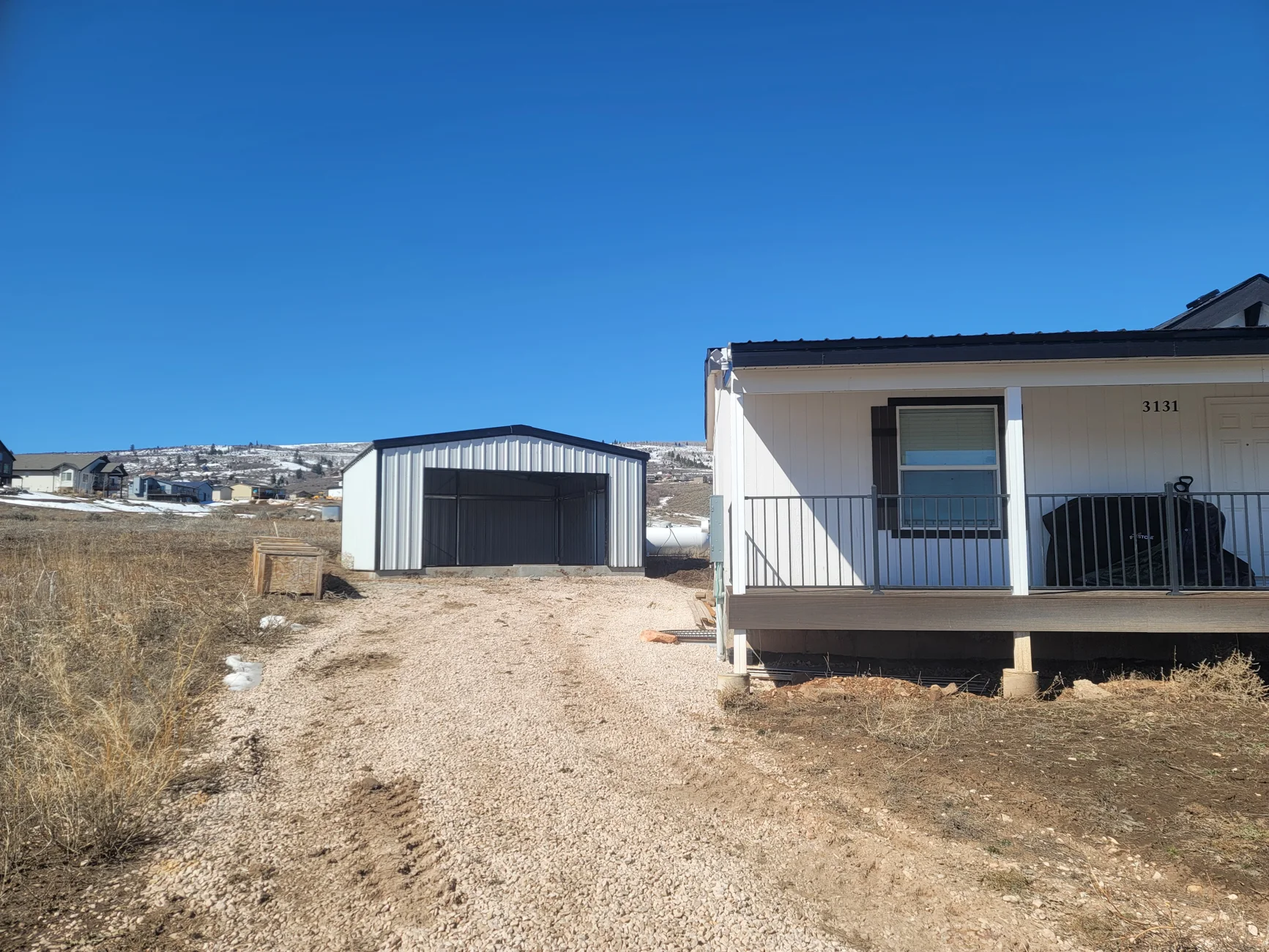 Detached metal garage beside a residence