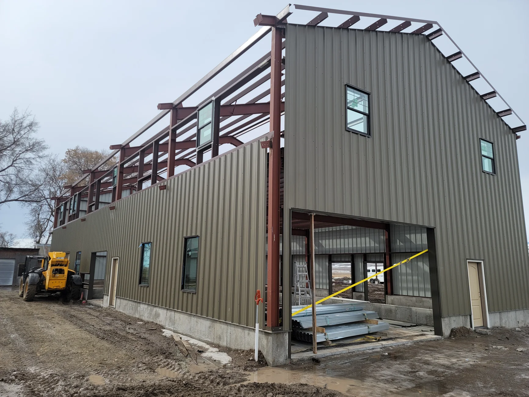 Steel building under construction showing framing and metal wall panels
